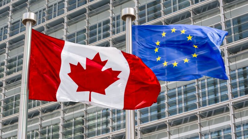 Das Bild zeigt eine Europa- und eine kanadische Flagge.